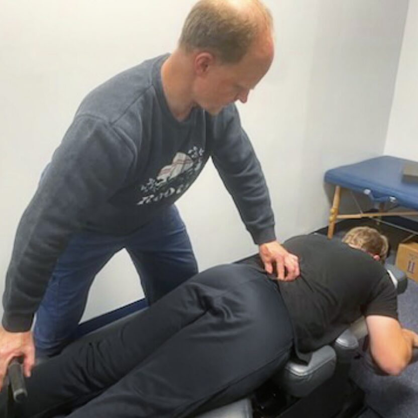 Miami Athletic Club chiropractor adjusting a man's back.