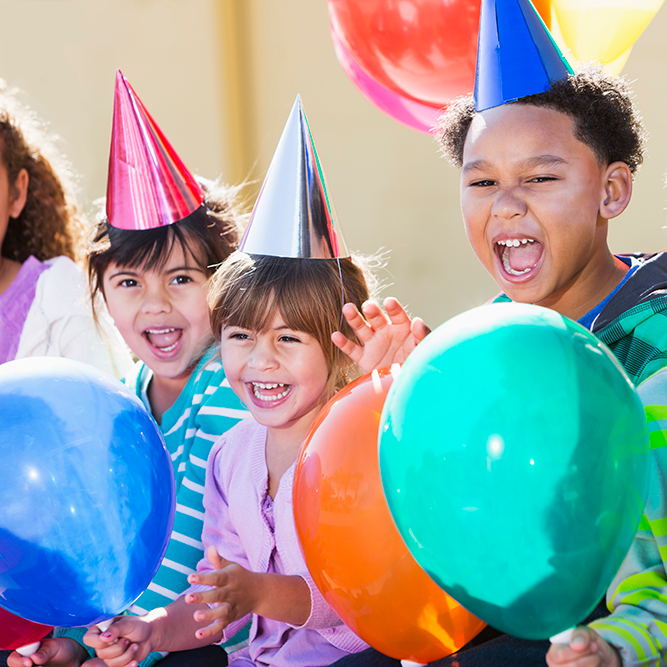 Miami Athletic Club children wearing birday hats with balloons