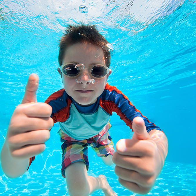 Miami Athletic Club boy underwater in a pool giving a thumbs up