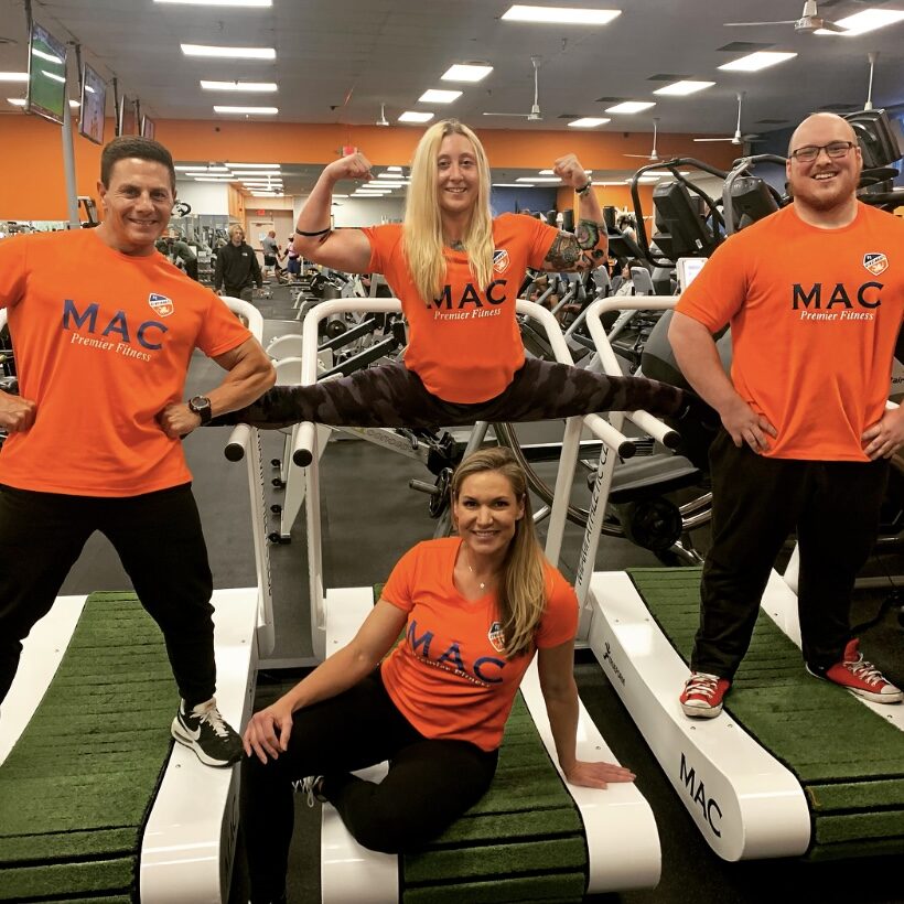 Miami Athletic Club personal trainers, posing on equipment
