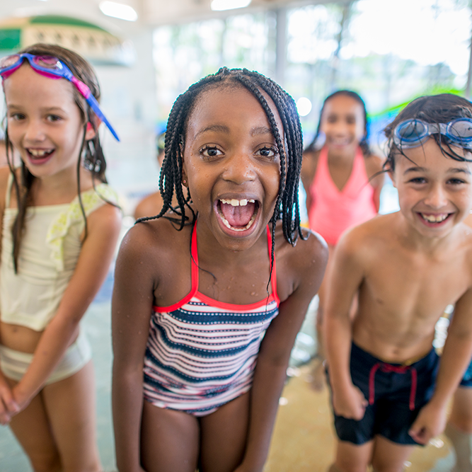 Miami Athletic Club group of children wearing swim goggles at pool